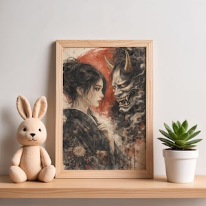May include: Watercolor print in a wooden frame. The artwork depicts a woman in a kimono facing a demon with horns. A red sun is in the background. A plush bunny and a potted succulent sit on a wooden shelf.