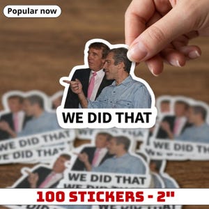 May include: A sticker featuring two men with the text "WE DID THAT". The sticker is white with a photograph of two men in suits and a button-down shirt. The sticker is 2 inches in size and the text "100 STICKERS - 2" is at the bottom.
