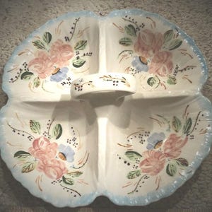 May include: A white ceramic mug with a black handle and the text "But First, Coffee" in a black, bold font. The mug is sitting on a white surface. The mug is approximately 4 inches tall.