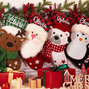 May include: Four festive Christmas stockings, each personalized with a name: Claire, Olivia, Sylvia, and Elvin. The stockings feature a reindeer, Santa, a polar bear, and a penguin. Red and green decorations with gifts.