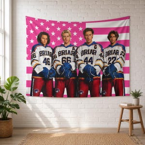 May include: A rectangular wall tapestry featuring a pink and white American flag background with four individuals wearing white, blue, and red hockey jerseys. Each jersey displays the text BRIAR, a unique number, and blue gloves are worn by each.