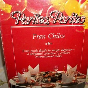 May include: A red book cover with the title "Parties Parties" and the author's name "Fran Chiles". The book cover features a decorative design of balloons and a table setting with candles and plates.