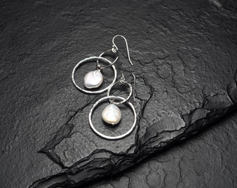 white coin pearl inside two intertwined sterling silver circles, dangle earrings, ildiko jewelry, minimalist jewelry