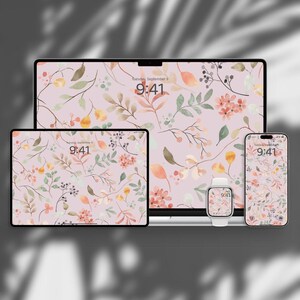 May include: A collection of digital devices, including a laptop, tablet, smartphone, and smartwatch, all displaying a floral wallpaper. The wallpaper features a watercolor design with pink, yellow, and green leaves and flowers. The time displayed is 9:41.