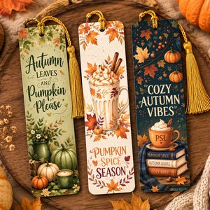 May include: Three rectangular bookmarks with yellow tassels. The first features green pumpkins and the text Autumn Leaves and Pumpkin Please. The second shows a whipped cream drink and Pumpkin Spice Season. The third displays books and Cozy Autumn Vibes.