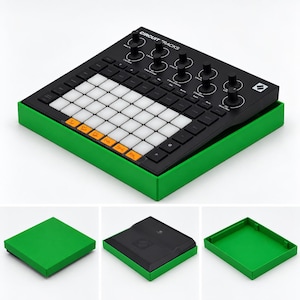 May include: A black Novation Circuit Tracks groovebox with a grid of white and orange backlit pads and rotary knobs, resting inside a bright green plastic tray. The device features the text CIRCUIT TRACKS printed on the top surface.