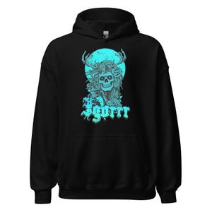 May include: Black hooded sweatshirt with a teal graphic. The graphic features a skull with antlers, roses, and the word "Igorrr" in teal. The design is set against a teal circle.