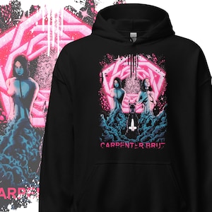 May include: Black hooded sweatshirt with a graphic design featuring two figures in a pink and blue surreal scene. The text "CARPENTER BRUT" is printed in pink at the bottom of the design. The design is on the front of the sweatshirt.