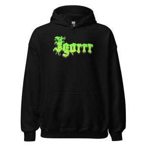 May include: Black hooded sweatshirt with a front graphic. The graphic features the word "SGORR" in a green, stylized font with a shadow effect. The sweatshirt has a drawstring hood and a front pocket.