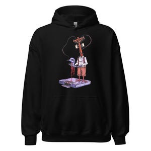 May include: Black hooded sweatshirt featuring a surreal graphic. The design includes a figure with a utility pole head, holding a bird, with the text "Venetian Shades" on a rectangular base. The artwork is in shades of red, blue, and white.