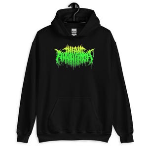 May include: Black hooded sweatshirt with the text "INFANT ANNIHILATOR" in a green and yellow dripping font. The sweatshirt has a front pocket and a drawstring hood. The Gildan logo is visible on the tag.