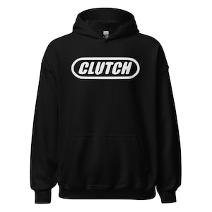 May include: Black hooded sweatshirt with the word "CLUTCH" in white, inside a white oval. The sweatshirt has a front pocket and a drawstring hood.