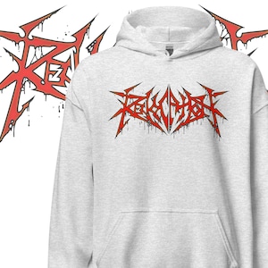 Könnte beinhalten: Hellgrauer Kapuzenpullover mit einem rot-schwarzen Grafikdesign. Die Grafik zeigt stilisierten Text und scharfe, gezackte Linien. Der Hoodie hat eine Kapuze mit Kordelzug und eine Vordertasche.