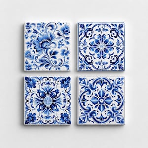 May include: A set of four square ceramic tiles featuring intricate blue and white floral and geometric patterns. Each tile displays a unique symmetrical design with detailed scrollwork, petals, and leaves arranged in a repeating decorative motif.