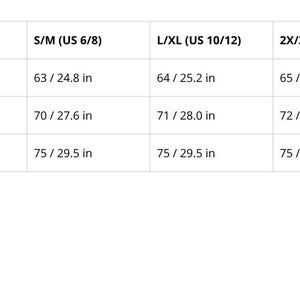 May include: A white table displays a size chart for clothing measurements. The chart includes back length, sleeve length, and inseam length in inches for sizes S/M, L/XL, and 2X/3X. The back length ranges from 24.8 to 25.6 inches.