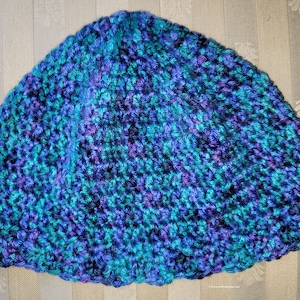 May include: A blue and purple crocheted beanie hat with a textured pattern.