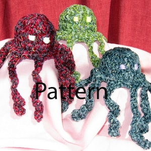 May include: Three crocheted octopus plushies in different colours: red, green, and blue. The plushies have white eyes and are sitting on a pink surface. The word "Pattern" is written in black letters on the surface.