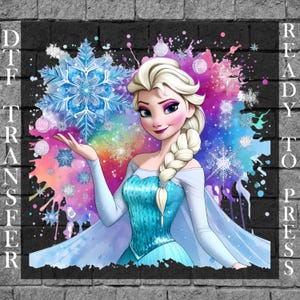 May include: A DTF (Direct to Film) transfer featuring a watercolour illustration of a princess with blonde hair in a braid, wearing a blue dress. The image includes a large blue snowflake and the text "READY TO PRESS". The background has colourful paint splatters.