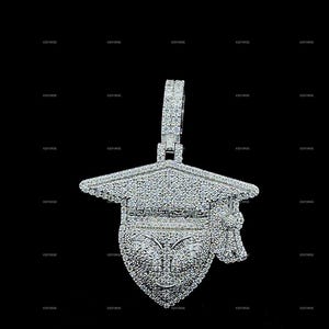 May include: A diamond-encrusted graduation cap pendant. The pendant features a detailed design of a mortarboard with a tassel, all covered in sparkling gemstones. The bail is also encrusted with diamonds, creating a luxurious look.