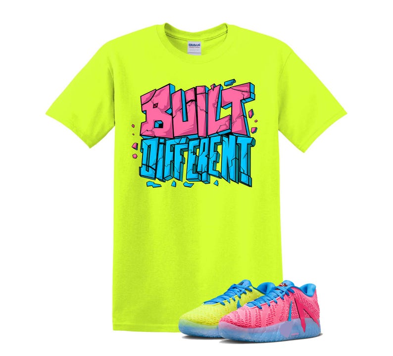 May include: A neon yellow t-shirt with the words "BUILT DIFFERENT" in pink and blue block letters. The shirt is paired with a pair of colorful sneakers, one yellow and blue, the other pink and blue.