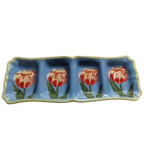 May include: A rectangular serving dish with four sections. The dish is light blue with a yellow trim. Each section features a red and white tulip design with green leaves. The dish is ideal for serving snacks or appetizers.