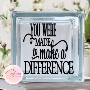 May include: A glass block with the text "You were made to make a difference" in black lettering. The block is clear and has a frosted finish.