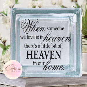 May include: A glass block with the text "When someone we love is in heaven there's a little bit of HEAVEN in our home."
