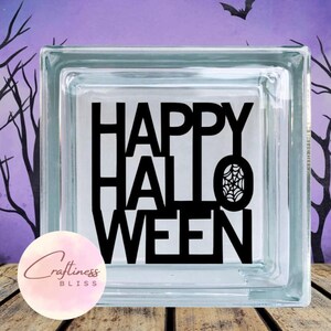 May include: A glass block with a black vinyl decal that reads "HAPPY HALLOWEEN" with a spider web design.