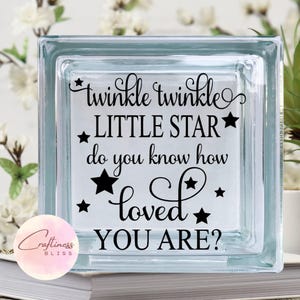 May include: A glass block with the text "twinkle twinkle little star do you know how loved you are?" in black lettering with stars.