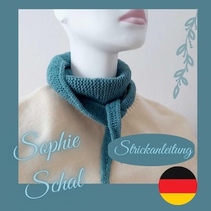 May include: A teal knitted cowl scarf is displayed on a mannequin. The scarf is wrapped around the neck and has a long, dangling section. The text "Sophie Schal" is written in cursive. The text "Strickanleitung" is also visible.
