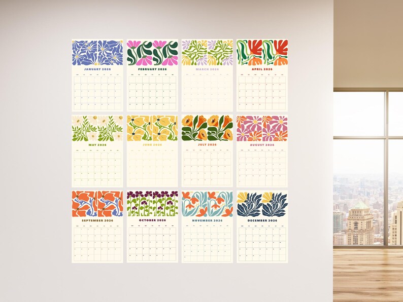 May include: A collection of twelve 2020 calendars, each with a unique floral pattern at the top. The calendars are displayed in a grid on a white wall. The floral designs incorporate various colours, such as blue, pink, yellow, and orange.