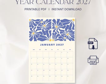 May include: A 2027 year calendar page for January featuring a cream background with a blue and yellow floral pattern at the top. The text reads YEAR CALENDAR 2027, PRINTABLE PDF, INSTANT DOWNLOAD, and JANUARY 2027. Includes PDF and printer icons.