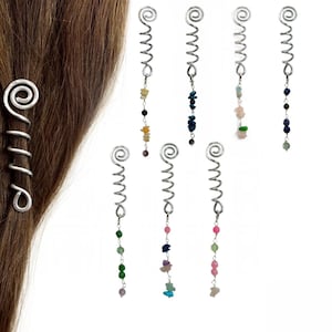 May include: A collection of seven silver-toned metal hair spirals, each featuring a coiled top and a dangling chain of small, multi-colored gemstone chips. One spiral is shown twisted into a lock of brown hair, while the others are displayed individually.