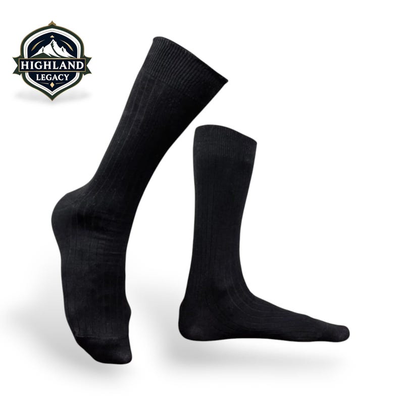 May include: Two black ribbed socks, one angled and the other upright, are displayed against a white background. The socks are knee-high and have a textured, vertical ribbed pattern. The Highland Legacy logo is in the upper left corner.