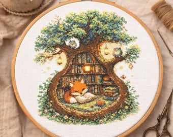 May include: A cross-stitch embroidery in a wooden hoop depicts a whimsical scene. A fox reads in a tree-shaped library, surrounded by books, owls, and lanterns. The artwork features a detailed design with various colors, creating a cozy, storybook atmosphere.