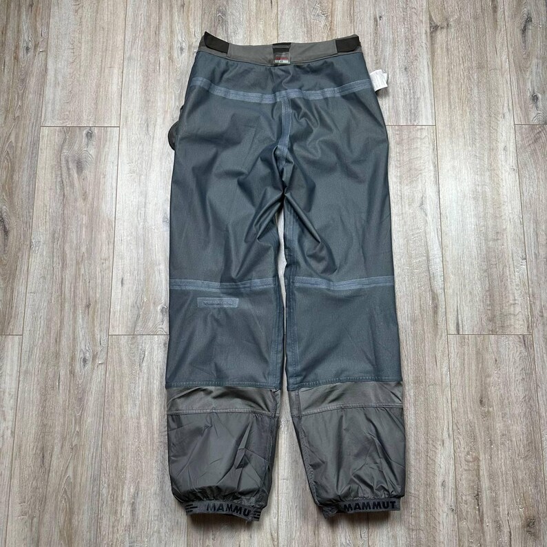 May include: A set of three ceramic mugs with a speckled, matte finish. Each mug features a different color: light blue, cream, and gray. The mugs have a simple, modern design with a rounded shape and a comfortable handle.