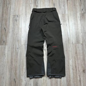 May include: A set of three ceramic mugs with a speckled, matte finish. The mugs are in shades of cream, light gray, and dark gray. Each mug has a simple, minimalist design and a rounded handle.