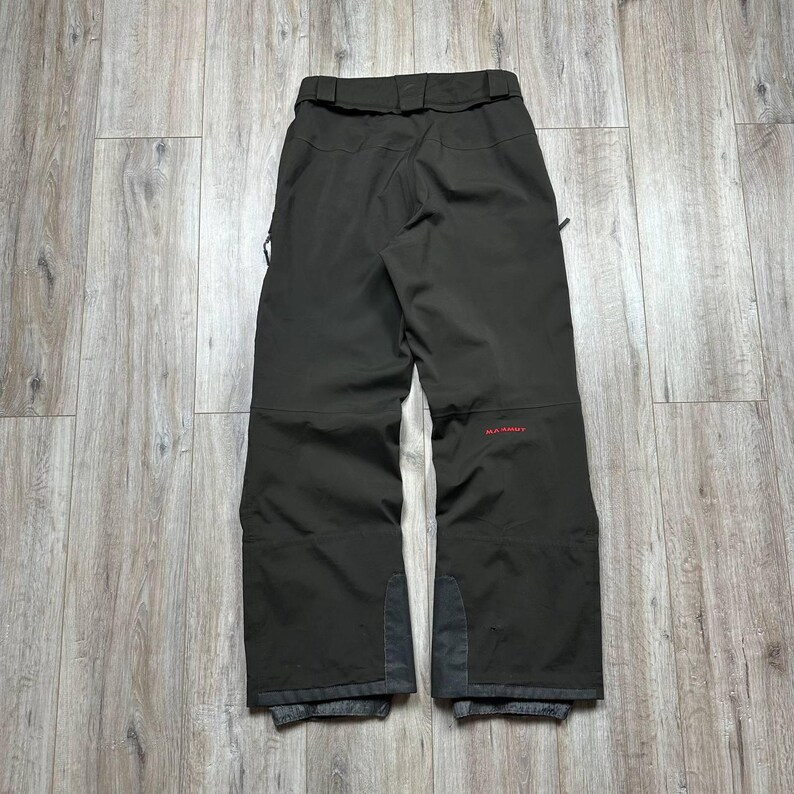 May include: A set of three ceramic mugs with a speckled, matte finish. The mugs are in shades of cream, light gray, and dark gray. Each mug has a simple, minimalist design and a rounded handle.