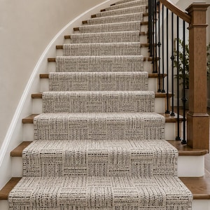 May include: A curved staircase with woven carpet in shades of beige and brown. The carpet has a geometric pattern and is installed on wooden steps. The staircase features a wooden handrail and black metal balustrades.