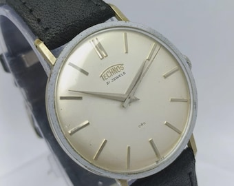 Reloj vintage Technos de cuerda manual con esfera blanca para hombre ALM339ABR8