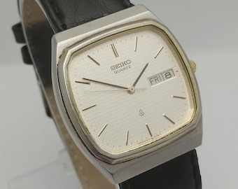 Vintage Seiko Quartz Men's Watch: Silver Dial, Black Leather Strap