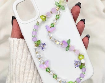 Correa para teléfono con dije de cuentas estilo Fairycore, cuentas de vidrio en tonos pastel, setas, flores de mariposa y dije de ojo turco.