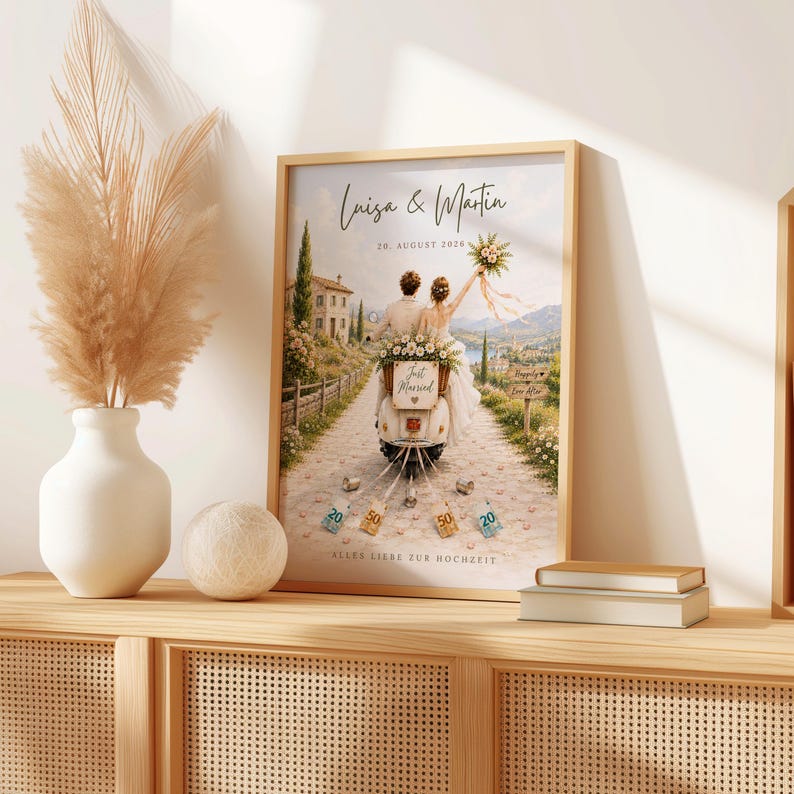 May include: A framed print featuring a couple on a scooter with the text Luisa & Martin, 20. AUGUST 2020, Just Married, and ALLES LIEBE ZUR HOCHZEIT. The illustration shows a scenic path, a stone building, and money tied to the back of the scooter.