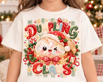 May include: A white short-sleeve t-shirt featuring a graphic of a winking dumpling wearing a Santa hat inside a bamboo steamer. The text reads DUMPLING CLAUS, surrounded by Christmas elements like candy canes, gifts, and stars.
