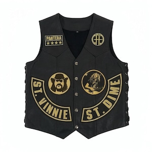 May include: A white ceramic mug with a black handle and the text "But First, Coffee" in a bold, black font. The mug is set against a blurred background, suggesting a cozy setting.