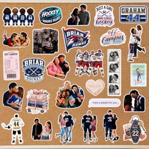 May include: A collection of stickers on a corkboard, featuring hockey-themed designs, couples, and text like "Hockey Romance Reader" and "Briar Hawks." The stickers vary in size and shape, with a mix of colors.