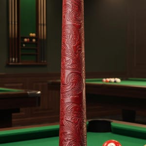 May include: A crimson leather pool cue grip featuring an embossed paisley pattern and the text "CRIMSON PAISLEY" near the base. The grip is part of a wooden pool cue with silver accents, positioned vertically against a dark background.