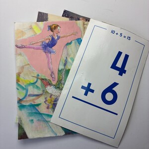 May include: A stack of vintage educational cards. One card features a ballerina in a blue leotard and pink tights. Another card displays the math problem "4 + 6 =" with the answer. The cards have a watercolor style.