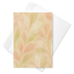 Könnte beinhalten: Eine Grußkarte mit einem Aquarelldesign aus überlappenden Blättern in Pfirsich-, Beige- und Grüntönen. Sie wird von einem weißen Umschlag begleitet, ideal zum Versenden einer persönlichen Nachricht. Das Design der Karte eignet sich für verschiedene Anlässe.