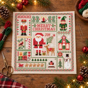 May include: A cross-stitch sampler on beige fabric featuring a central Santa Claus, a reindeer, and the text Merry Christmas and Joy. The design includes a nutcracker, an elf, a snowman, a house, gifts, and trees in red, green, and black thread.